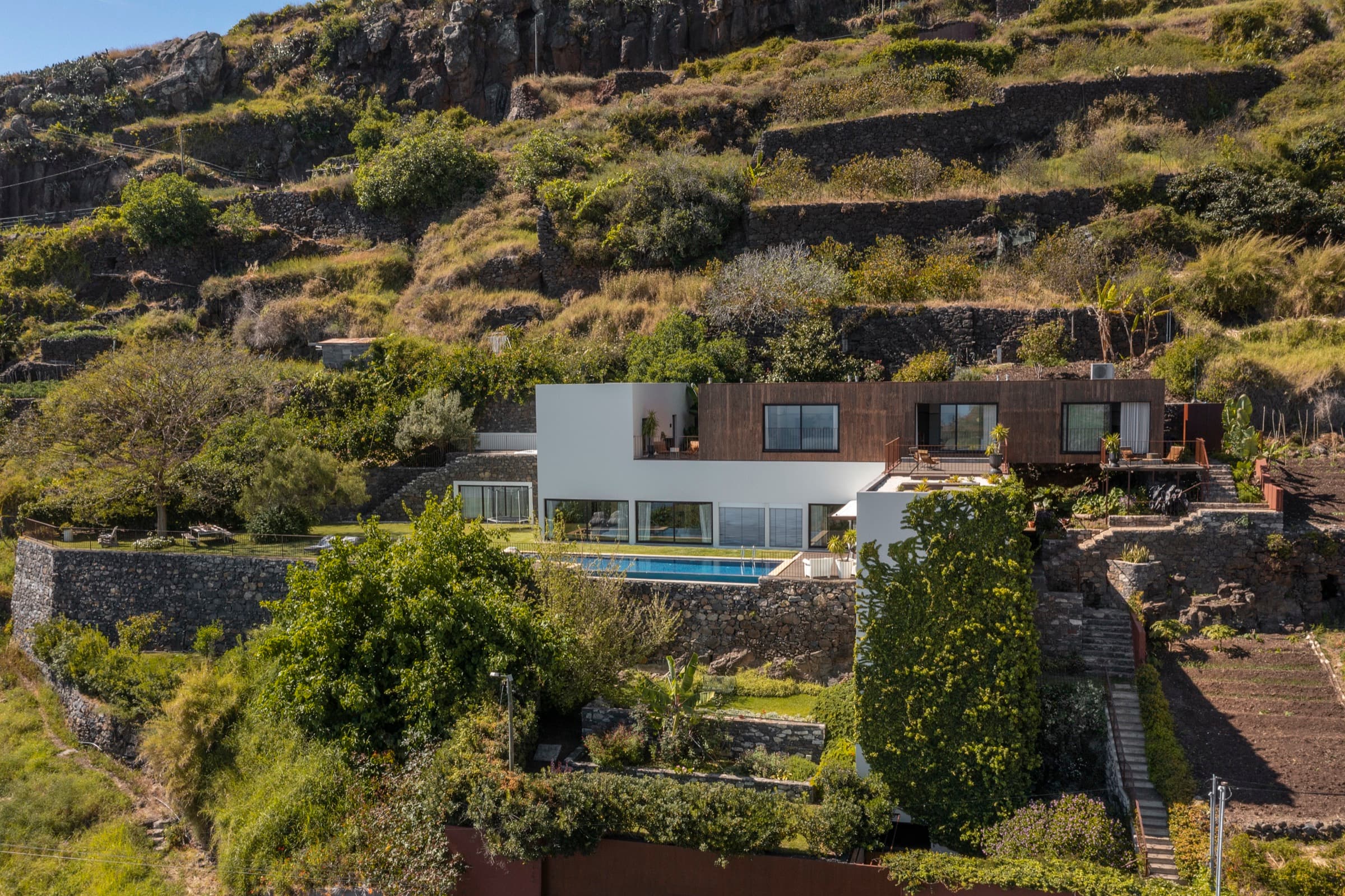 Aerial view of Botânica Living nestled in the Madeira hillside