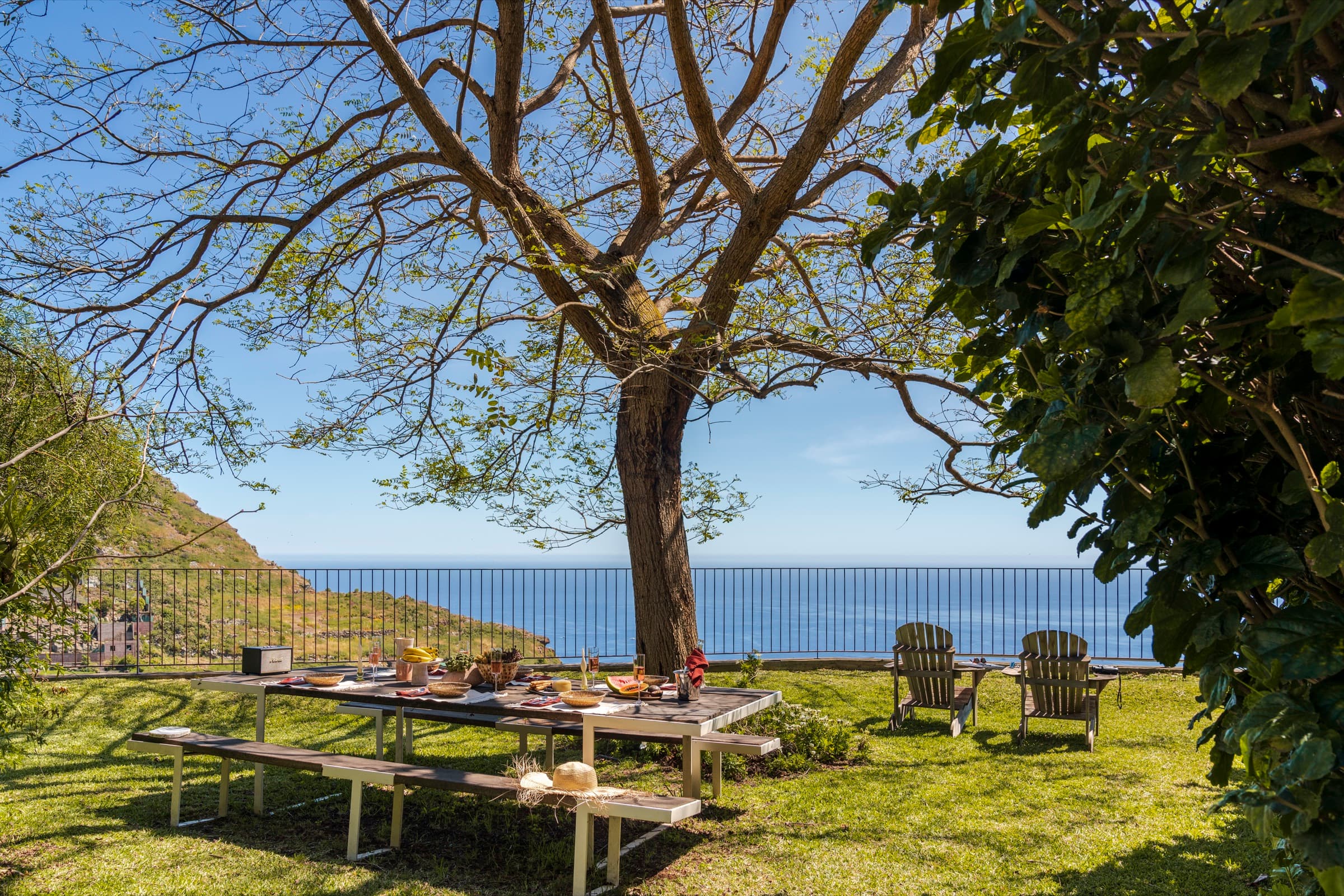 Alfresco dining under the trees with sea views