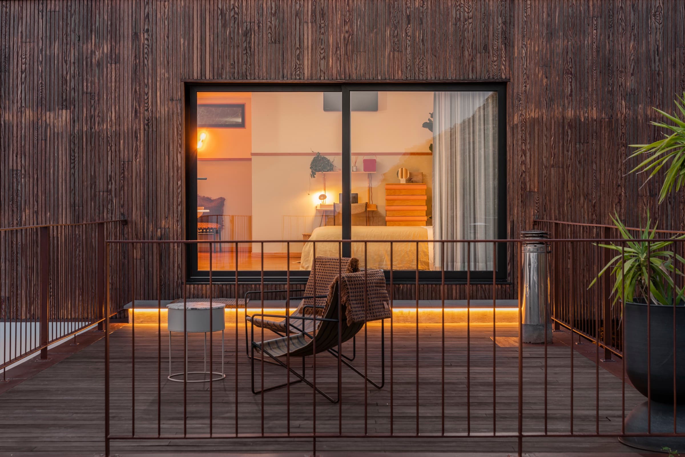 Terrace and bedroom glowing at dusk